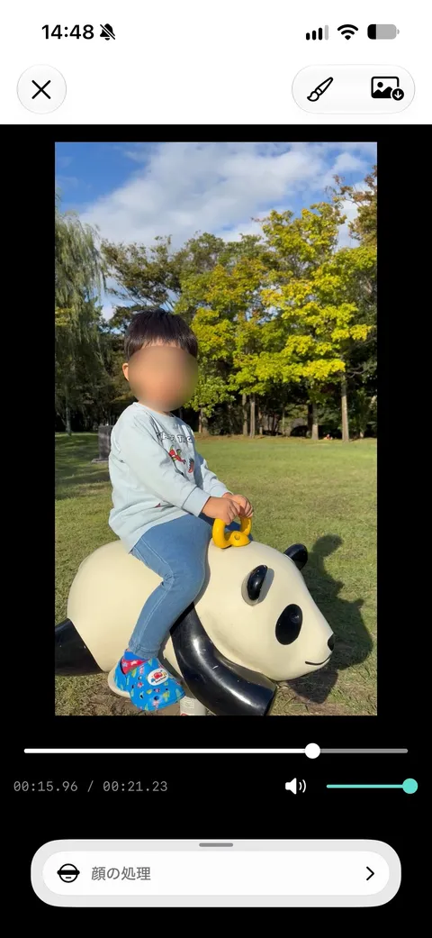 iPhone editor showing a blurred face in a video of a child playing in a park
